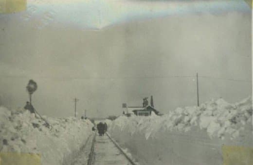 The crossing keeper's cottage, Battersby seen from the Kildale (eastern) end of the station, the single-storey cottage almost invisible under mountains of snow - the early square board signal is clearly visible