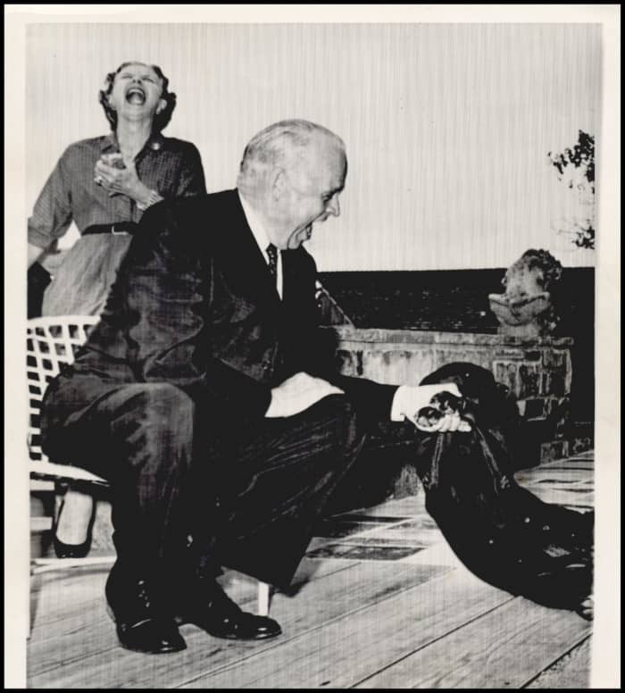 Sen Kerr was trying to get the dog to perform like he hopes it will when President Kennedy visits the Kerr home near Poteau.