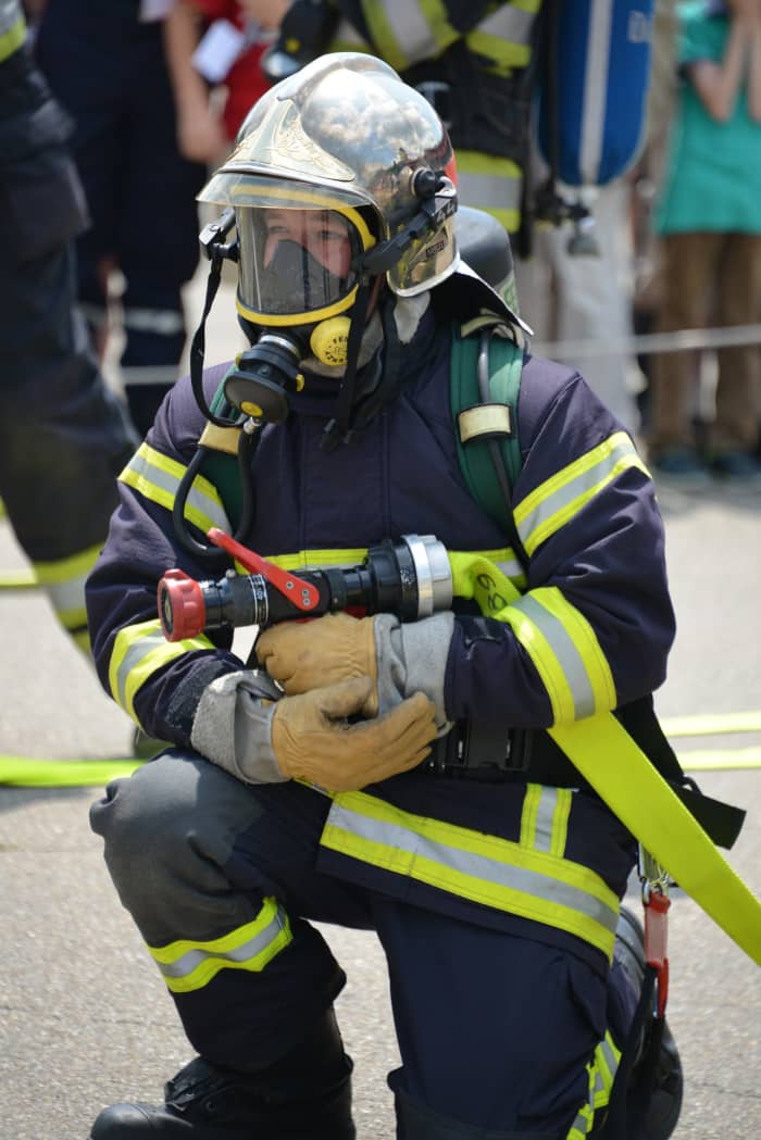 Many fire fighters wear gas masks, helmet, and other protective gear for protection from intense fire flames, heat, and burning chemicals.