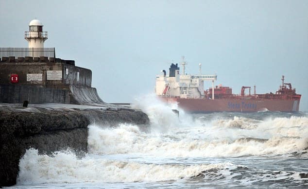 Looking past the South Gare beacon at a departing tanker - there is a steady flow of tankers and ore ships to Teesmouth, you'll see the pilot boats ploughing in and out through the surf. The beacon tower''s been replaced, by a pair of masts