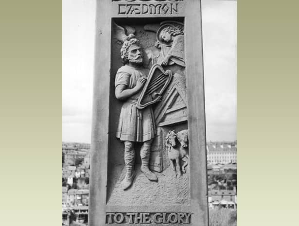 A panel of the cross showing the herdsman Caedmon with his lyre. He was a Celtic herdsman at Whitby Abbey in its early days