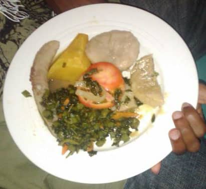 A typical Jamaican-Rastafarian vegetarian food with Boiled Yam, Banana, Dumpling with tomato and callaloo