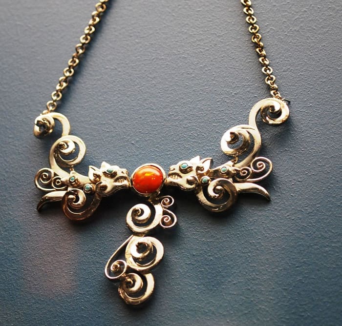 Silver necklace with ruby, emerald and Mexican opal with two jaguars in confrontation from Guadalajara Jalisco on display at the Museum of Artes Populares in Mexico City