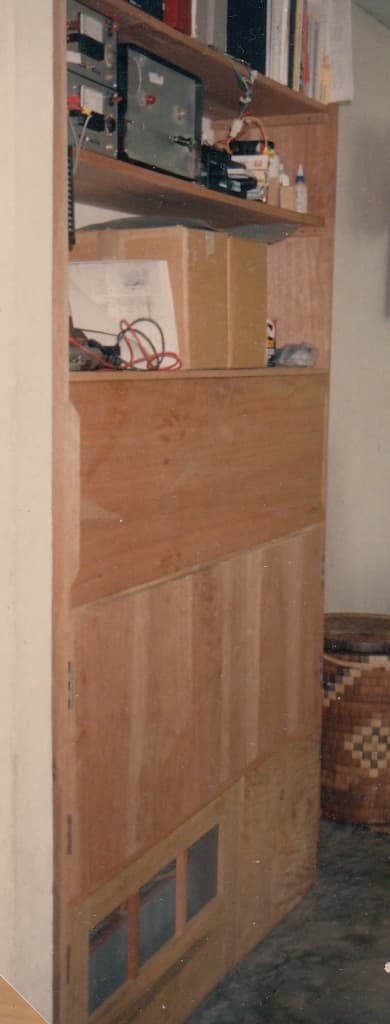 A centrally-located storage cabinet housed batteries below and charge controller above, doubling as linen closet, etc.
