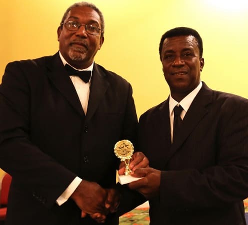 Former Leeward Islands Cricket Association (LICA) President and West Indies Cricket Board (WICB) Director Mr. Gregory Shillingford presents an award to Willett in June, 2014. Willett is on the right. – (WICB Media photo)