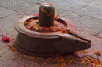 Shiva lingam (the rock) resting in its cradle (the yoni), the aniconic symbol of Shiva and all reality.