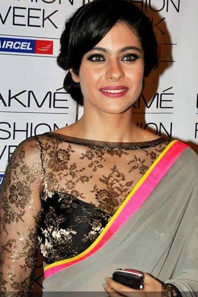 Lace Black Saree Blouse. The blouse isn't bad but worn with this saree it looks gaudy and the lining seems a bit to low for her body type.