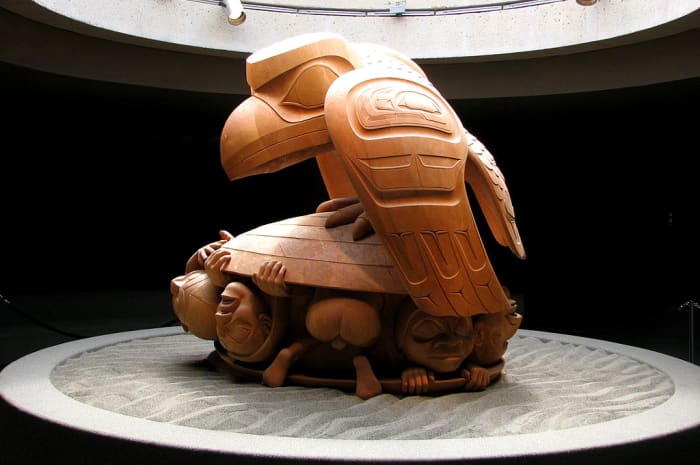Sculpture by Bill Reid showing Raven releasing first men from a cockle shell. Bill Reid is an artist from the T'anuu (Haida) Raven/Wolf Clan.