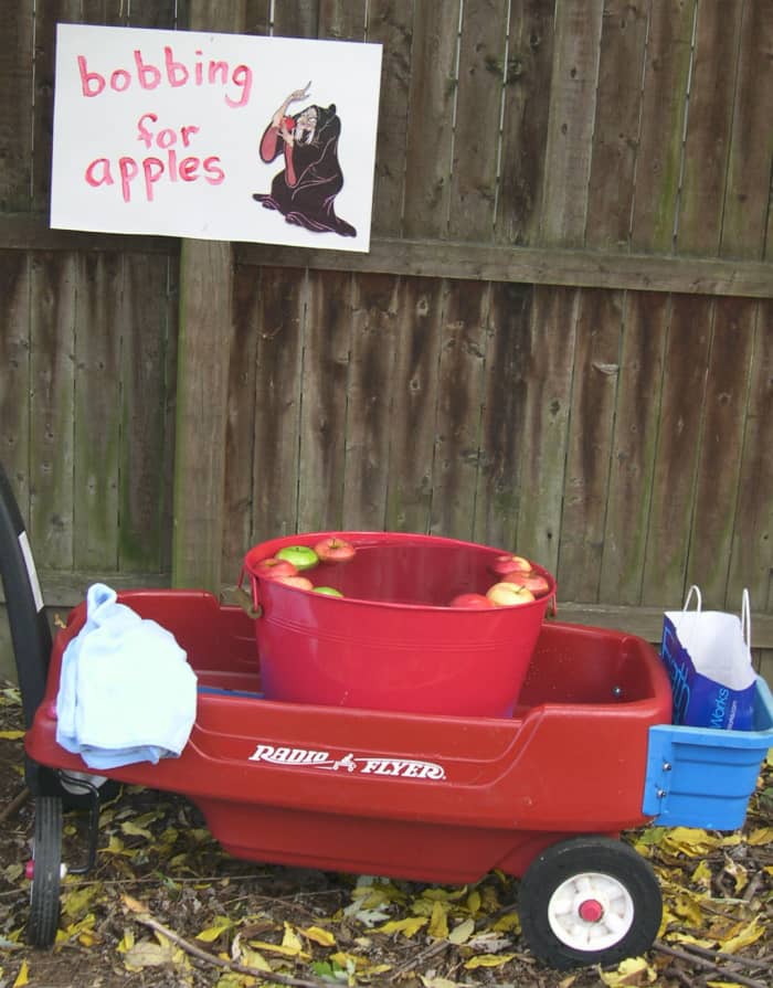 Place the tub for the apple bobbing game in a wagon so it is the right height for little ones. Also provide a towel or two so kids can dry their faces.