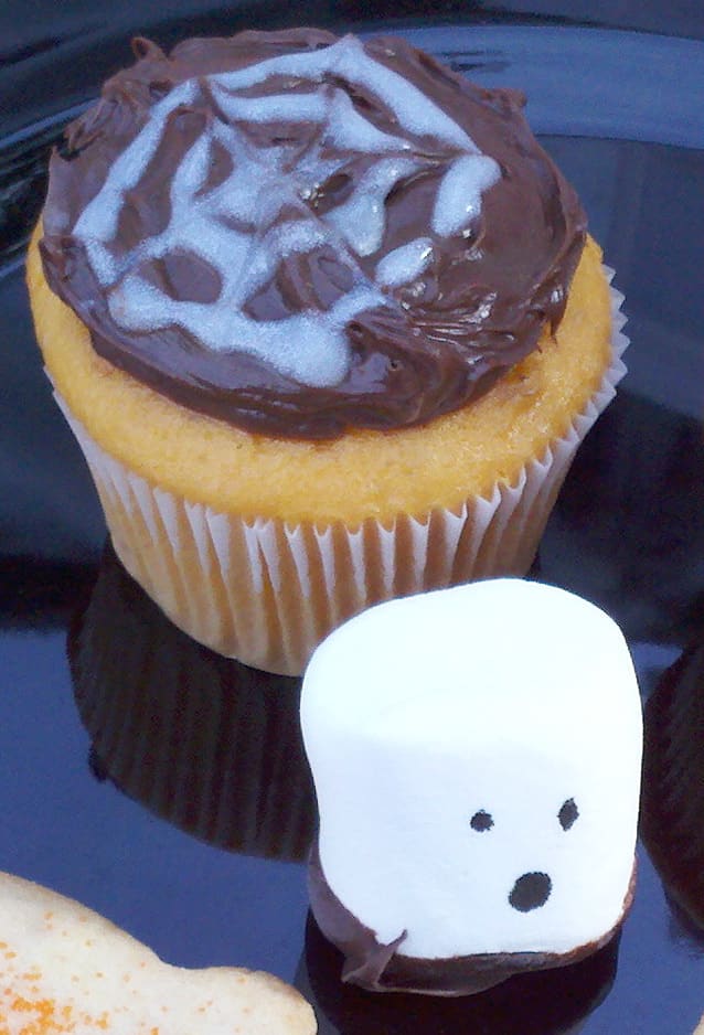 Spider web cupcakes and ghost marshmallows are easy to make treats for a Halloween party.
