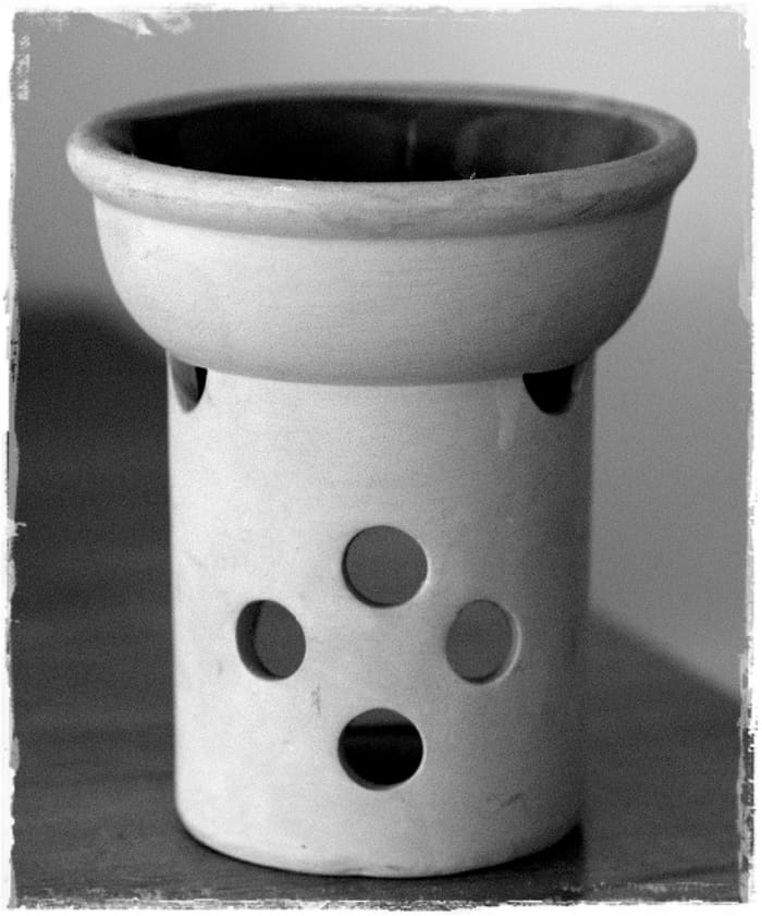 Oil burners can be bought in many styles and designs. For magic, chose one that has a good sized well in which to place water and oils.