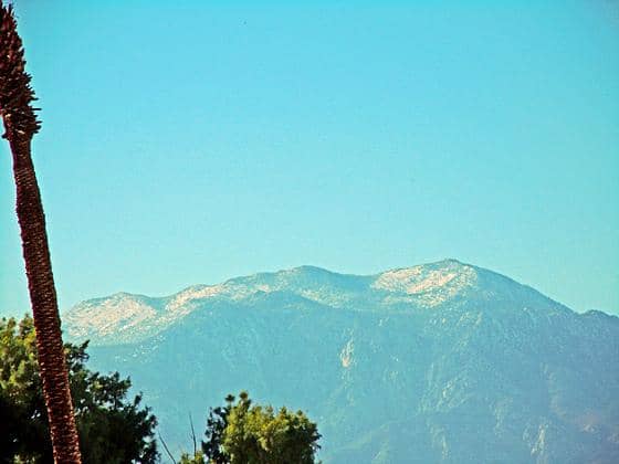 Winter camping in Palm Springs, California. Palm trees below and snow on the mountain tops.