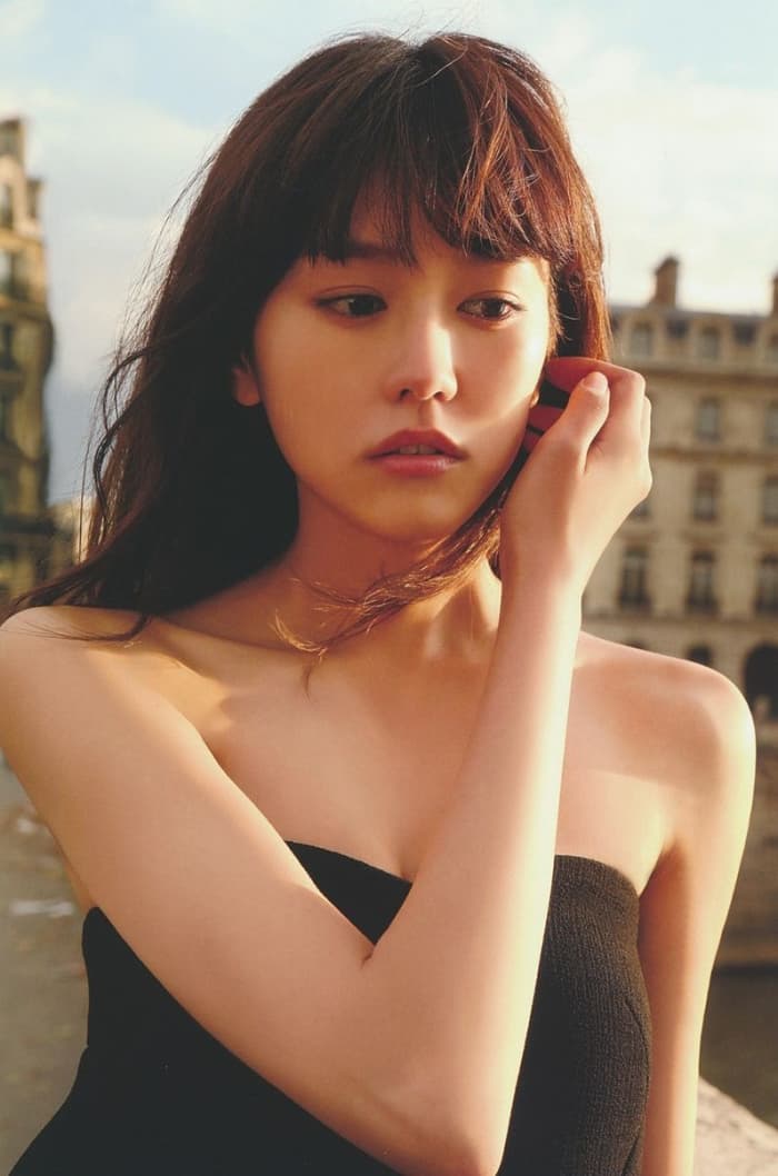 A photo of the beautiful Mirei Kiritani from her first photo book called Shitsuren Ryokou Paris as she poses for a photo in Paris, France.
