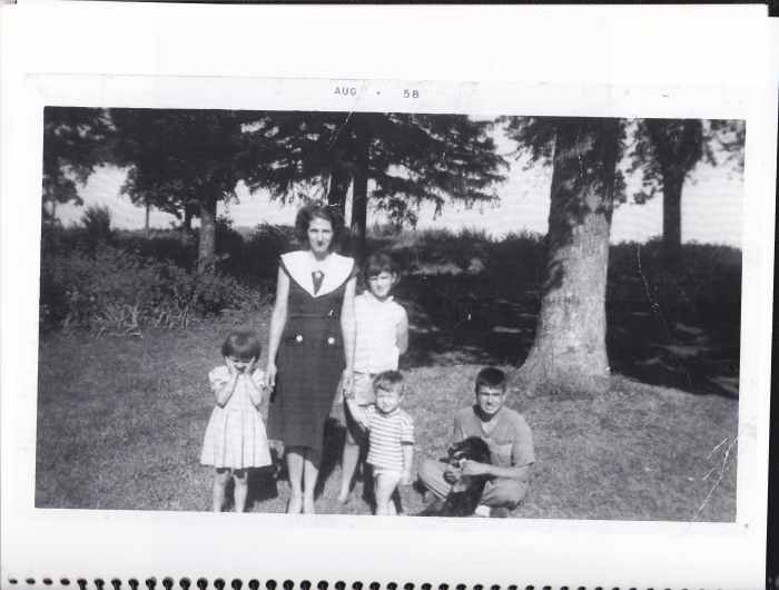 Picture taken in 1958 on the front lawn of our property. Holding a dog, I am pictured with my mother, oldest sister, Beatrice, sister Pat, and toddler brother Philip.