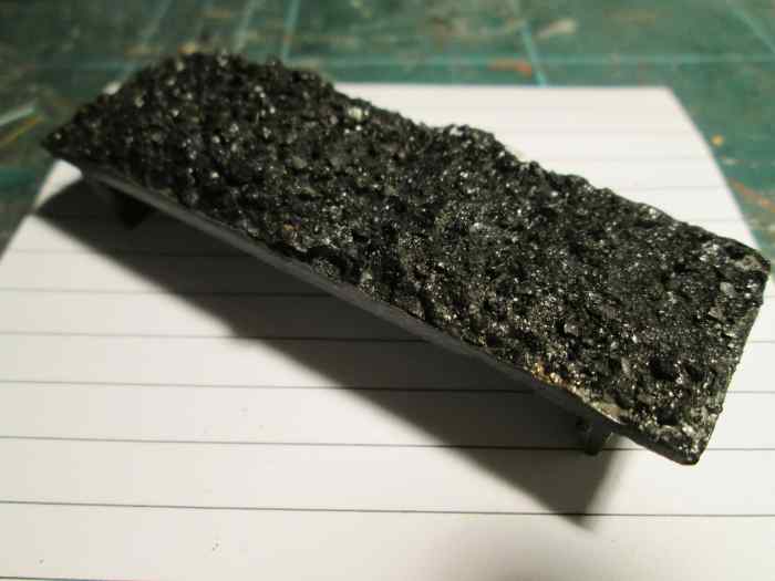 The coal load that comes with the model from the retailer is fairly innocuous. I add real coal on a layer of white pva glue that dries invisibly
