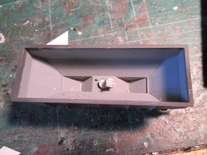 This extrusion can be eliminated in seconds with side cutters, although strictly speaking it's not necessary. The 'wedge' would cover it easily. It's your choice....