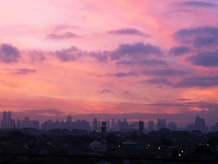 Photo of sunset over the Indonesian capital of Jakarta. Photo by flydime and distributed under Creative Commons Attribution 2.0 license.