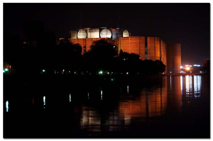 The parliament building of Bangladesh in Dhaka at night. Photo by Silver Surfer -{ Ariful H Bhuiyan }- and distributed under Creative Commons Attribution 2.0 license.