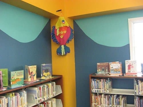 Paint creates a water feel as well on the walls. An inexpensive paper fish hanging from the ceiling adds more color and fits the theme.