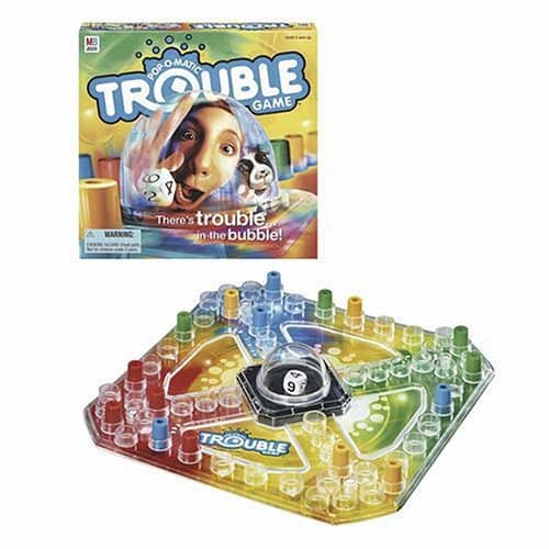 The Trouble game board features a "Pop-o-matic" bubble encasing a single die, and 16 game pegs in 4 colors.