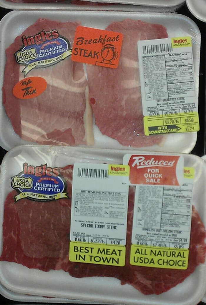 Many times labels or stickers are used to hide flaws or clumps of fat in the meat. You are within your rights as a consumer to open the package and look at the meat. They can always rewrap it in just a few seconds.