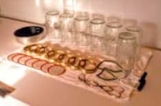 Meanwhile, check jars for nicks, cracks, and other problems. Do not use jars that are damaged. Wash in hot, soapy water. Scald if necessary (may use dish washer to clean and sterilize). Wash lids and rings.