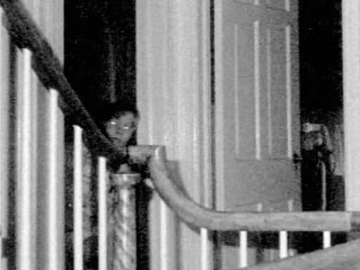 A ghostly figure seen peering out from a doorway. This was taken with infrared film during an investigation after the Lutz family fled the house.