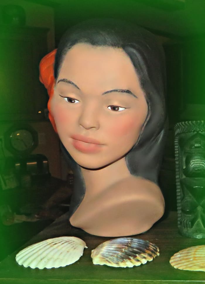 She is made of fine porcelain and there are no chips or cracks. She has the most remarkable serine and stately pose, and she is exquisitely hand painted by a local Hawaiian artist.