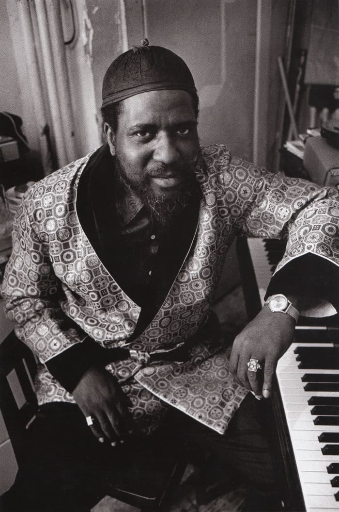 Monk photographed for a Saturday Evening Post Feature in 1963, and Monk is sitting next to his piano dressed in a silk robe.