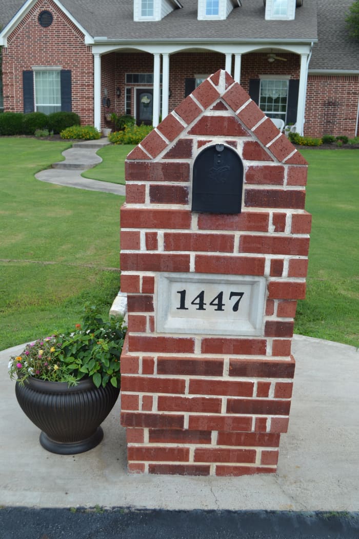 My engraved stone address marker was a faded, moldy mess until I cleaned it and repainted it. Here's how nice it looked after I was done!