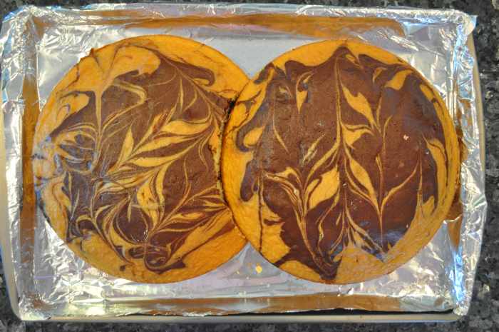 Once the cakes have cooled, you will need to make a platform for decorating your cake. Cut out a section of one cake, as illustrated above, to get the cakes to fit together in the shape of an 8.