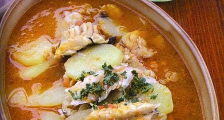 Fishermen's Stew, made of dry codfish (bakalar). It is served on Christmas Eve with sliced potatoes and a red or white broth. The fish must be soaked in water for several days before cooking.