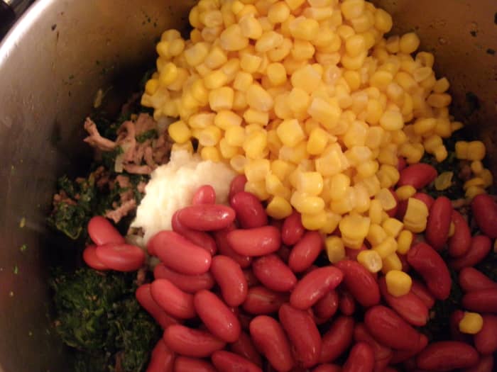 I added a bag of frozen spinach to the ground beef, and let it cook while I rinsed the beans. Then I added the beans, corn, and garlic and ginger paste.