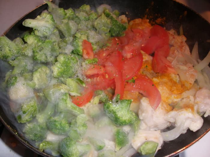 I have added a bag frozen broccoli and a sliced tomato to the chicken and sliced onions. I added more broccoli after the photo was taken, because I prefer a higher vegetable to meat ratio.