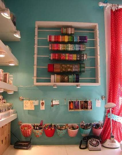 Here's another example of a dowel system but without paper clips so you have to slide other rolls off to take out empties. The wall mounting is nice.