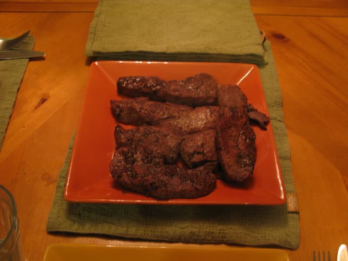 The finished pork chops are covered in the red wine marinade and much of the flavor will have soaked into the meat.