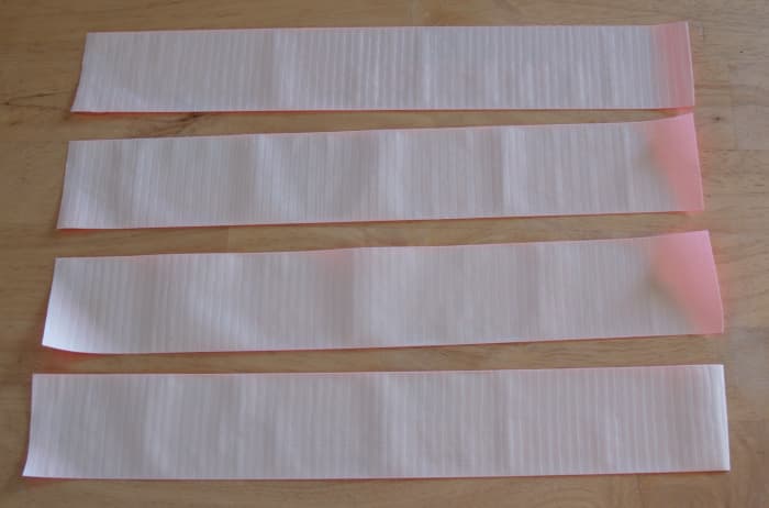 Cut four strips of Duck® Tape 11' to 13" long. Place the strips on your work surface with the sticky side up.