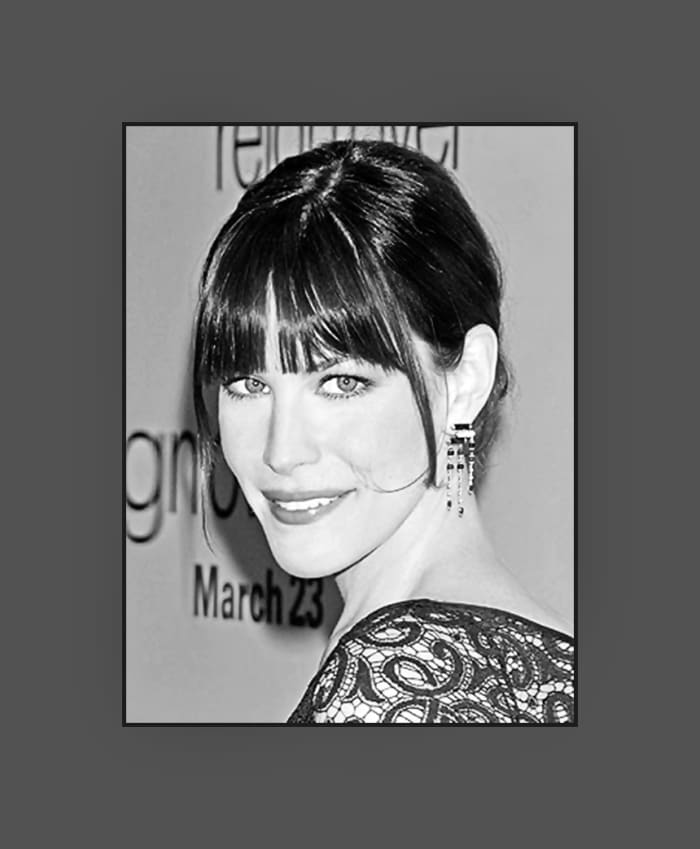 Liv Tyler's hairstyle with long choppy bangs is very flattering on her oblong face. The long strand on the side makes her updo very chic and trendy - 2013 Hairstyles with Bangs for Round, Oval, Square, Heart, Oblong Face