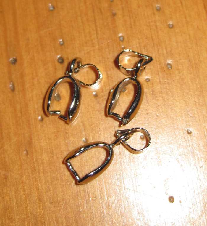 Standard pinch bails. These come in many sizes and are available with rhinestone embellishments.
