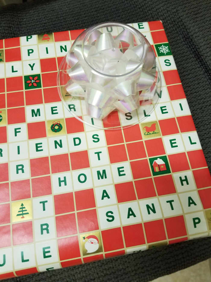 No need to fasten down the cup covering the bow. Just put plenty of crumpled newspaper or padding around so it doesn't shift during shipment. The bow will arrive in perfect condition.