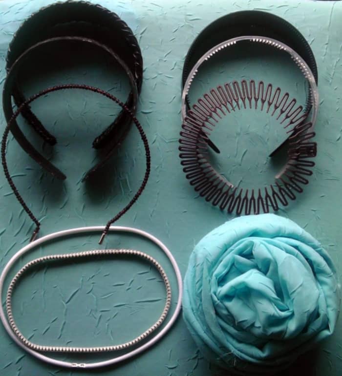 A selection of modern headbands. Clockwise from left: pleather, faux alligator, beaded wire, plastic with teeth, patterned with teeth, comb coil, elastic, elastic with grips, scarf