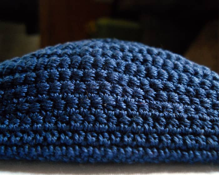 This photo shows the graduation of stitches from bottom to top. The purse begins with a round of sc's, hdc's, then varying heights of bullion stitches.