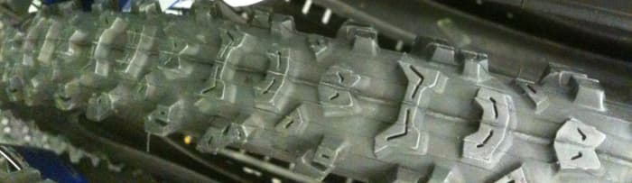 The tread of the Michelin Country Mud tire. A cheap and effective mountain bike tire for the mud with a narrower profile and lots of widely spaced tread knobs