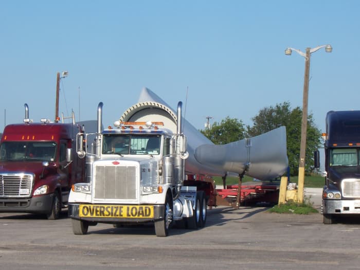 Smart grids are necessary to handle the variable and unpredictable load created by wind turbines like the one on this truck.