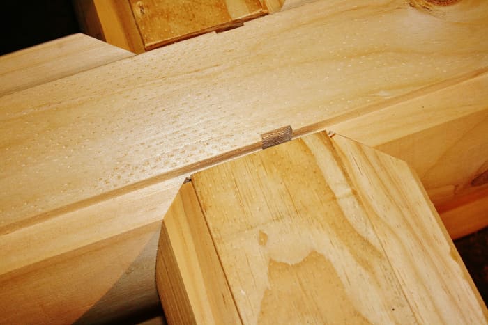 After lots of research, we opted to eschew chinking in favor of logs cut to fit (like Lincoln logs) with caulking and other weather proofing material between them.