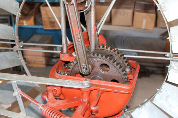 A gear box located behind the windmill blades create the push pull up and down stroke to operate the water well pump.