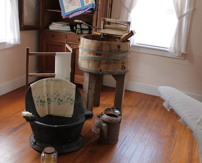 Most all the family bathing and laundry washing occurred in or close to the kitchen pitcher pump and wood stove used to heat the water.