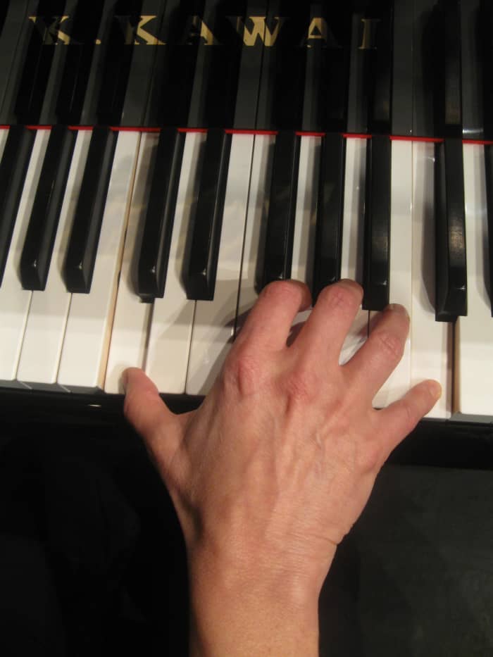 The same woman's hand playing an octave on a 15/16th piano. Note the more relaxed hand position playing the same notes on the slightly smaller 15/16th prototype Kawai piano keyboard made for pianist and teacher Erica Booker in Sydney, Australia.