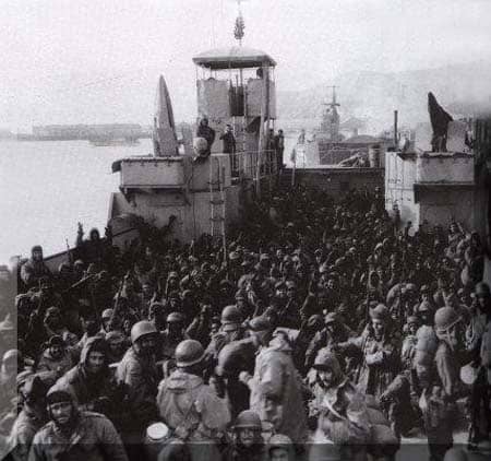 They made it: Marines huddle inside an LST after coming off the plateau. Look carefully at those faces, they capture every human emotion from elation to despair.