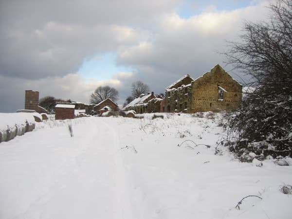 Abandoned, sorry-looking Slapewath buildings stand in winter snow awaiting an uncertain future